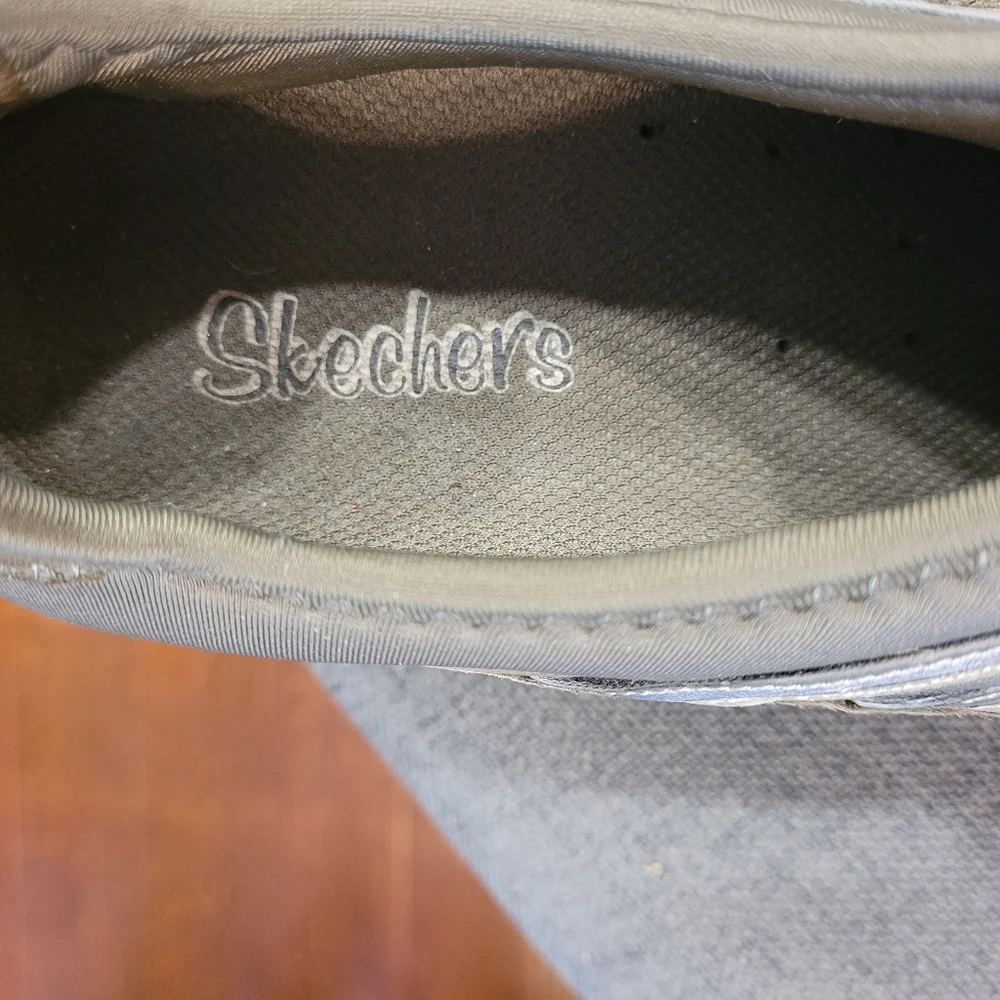 Skechers green outlined with gold ad gray. Slip on.